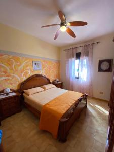 a bedroom with a bed and a ceiling fan at Casa Scala Dei Turchi in Realmonte
