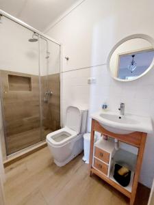 a bathroom with a toilet and a sink and a shower at Charme Apartment Center in Angra do Heroísmo +16 photos