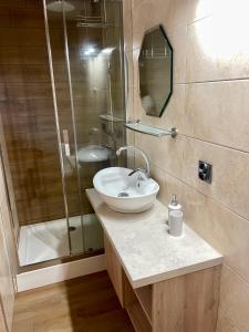 a bathroom with a sink and a shower at DIDA in Ostrowo