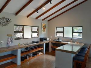 a large kitchen with a counter and some windows at Kosi Bay Casitas in Manguzi