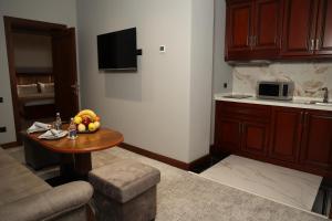 a kitchen with a table with a bowl of fruit on it at Mir Luxe Plaza in Tashkent