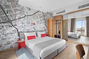 a hotel room with a large bed and a map at IntercityHotel Riyadh Malaz in Riyadh