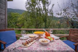 a table with plates of food and glasses of wine at SAKREFELA in K'eda