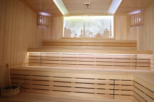 a sauna with wooden cabinets and a window at Mir Luxe Plaza in Tashkent