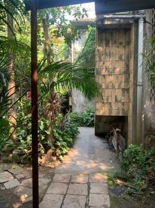 a stone walkway in a garden with a building at Secluded & green 2BHK in ancestral bunglow SCruz E in Mumbai