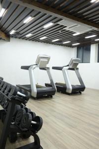 two rows of treadmills in a gym at Mir Luxe Plaza in Tashkent