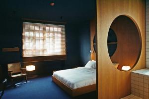 a bedroom with a bed and a round mirror at Blueberry Nights in Tbilisi City