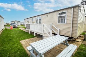 a white bench sitting in front of a caravan at Brilliant 8 Berth Caravan At Haven Caister Holiday Park In Norfolk Ref 30024d in Great Yarmouth