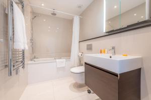 a bathroom with a sink and a toilet and a shower at Manson Place in London +63 photos