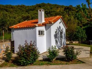 a small white chapel with a painting on it at Garden house No1 in Plomari