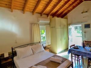 a bedroom with a bed and a table in a room at Garden house No1 in Plomari