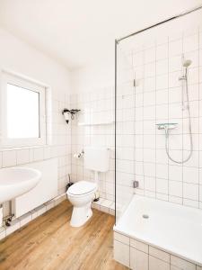 a bathroom with a toilet and a sink and a shower at Haus Menno Janssen - Doppelzimmer in Norderney