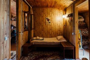 a small room with a bed in a wooden cabin at IRIS B&B in DEBED CANYON in Alaverdi