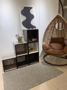 a living room with a rattan chair and a mirror at Day and Day Hotel No1 in T'ien-wei