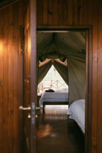 a bedroom with a tent with a bed in it at Kelora Bush Camp in Hoedspruit