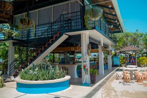 a building with a staircase and tables and chairs at Moalboal Tropics in Moalboal