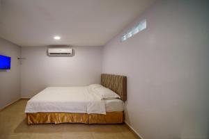 Postel nebo postele na pokoji v ubytování Hotel Uptown Semenyih