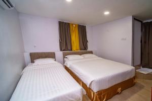 Postel nebo postele na pokoji v ubytování Hotel Uptown Semenyih