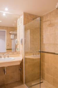 La salle de bains est pourvue d'une douche et d'un lavabo. dans l'établissement Howard Johnson Rio Cuarto Hotel y Casino, à Río Cuarto