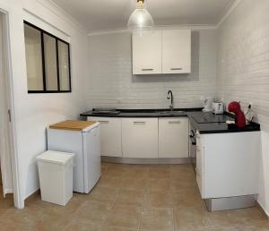 a kitchen with white cabinets and a sink at Accommodation in Sesimbra - Two Double Bedroom in Sesimbra
