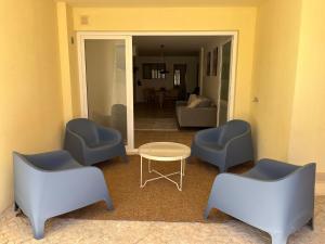 a room with chairs and a table and a living room at Accommodation in Sesimbra - Two Double Bedroom in Sesimbra