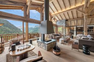 a living room with a fireplace in a mountain house at Ikaria - Chalet - BO Immobilier in Châtel