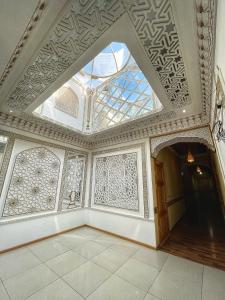 an empty room with a ceiling with a window at Hotel Nurafshon Boutique in Bukhara