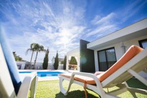 a patio with chairs and a swimming pool at Meirinha House in Viana do Castelo