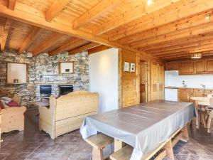 a dining room with a table and a stone fireplace at Chalet Peisey-Vallandry, 6 pièces, 10 personnes - FR-1-411-499 in Landry