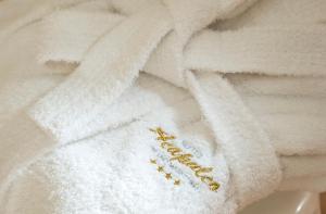 a pile of towels with the word recovery written on them at Hotel Acapulco in Milano Marittima