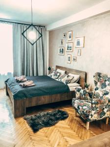 a bedroom with a bed and a couch and a chair at Royal flats Old Town in Krakow