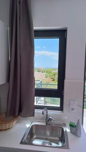 a sink in a kitchen with a window at Pagani Blue - Luxury Maisonette B3 in Kalamata +74 photos
