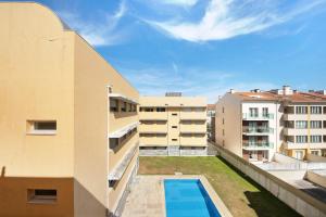 an apartment balcony with a swimming pool and buildings at Cantinho da Praia da Barra in Gafanha da Nazaré