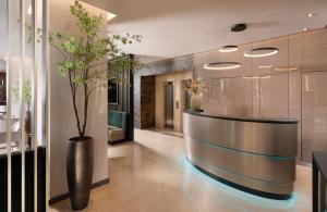 a lobby with a reception desk in a building at Leonardo Hotel Bucharest City Center in Bucharest