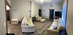 a living room with two white couches and a television at Modern Farmhouse 3 Bed, 2 Bath Apartment, Sleeps 7, Lots of Space, Steps to Downtown, Honeywell & Eagles Theater in Wabash