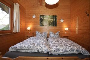 a bed in a wooden room with stars on the wall at Ferienpark Harmsen in Cuxhaven
