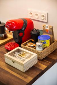 a red mixer sitting on top of a counter at Apt nuevo! 2 hab, baño doble, garaje, Metro a 200m in Madrid