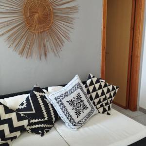 a couch with pillows on top of it at Guest House Oleandro IUN 2727 in Santa Maria Navarrese