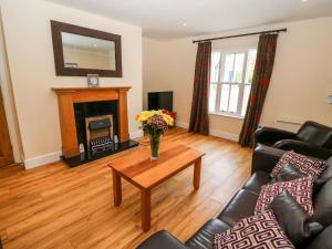 a living room with a table and a fireplace at No 3 an Seanachai in Dungarvan