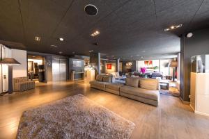 a living room with two couches and a rug at Hôtel & Spa L'Alta Peyra in Saint-Véran