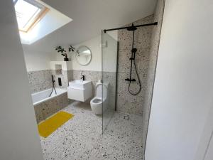 a bathroom with a shower and a toilet and a sink at Ideal Bristol getaway - 3 bed harbourside home in Bristol