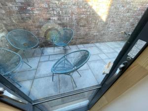 a view of three chairs sitting on a patio at Ideal Bristol getaway - 3 bed harbourside home in Bristol