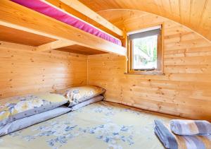 a room with two beds in a wooden cabin at 68 Degrees West Glamping in Brecon