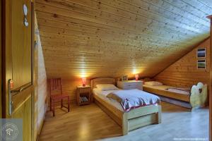 a room with two beds in a wooden cabin at Chalet Les Brimbelles avec Jacuzzi in Gérardmer