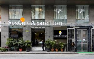 a person is standing outside of a hotel at Hotel Suncity Apollo, Colaba in Mumbai