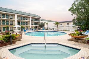 a swimming pool in front of a hotel at Econo Lodge Inn & Suites Foley-North Gulf Shores in Foley