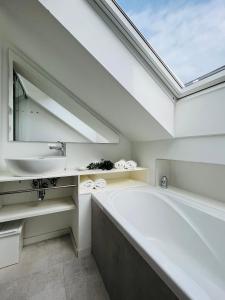 a bathroom with a large tub and a sink at House called Happiness in Jelsa +17 photos