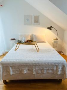 a bed with a tray of fruit on top of it at House called Happiness in Jelsa