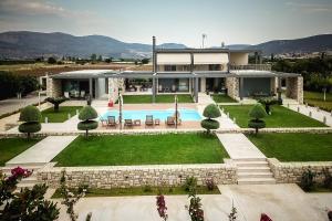 a house with a swimming pool in front of it at Gravaris House in Nafplio