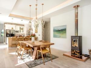 a dining room with a table and a fireplace at Wechmarshof in Stellenbosch